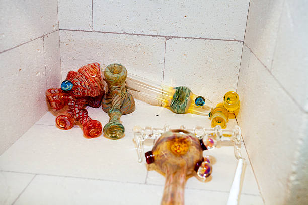 Many multicolor glass pipes laying in concrete kiln.