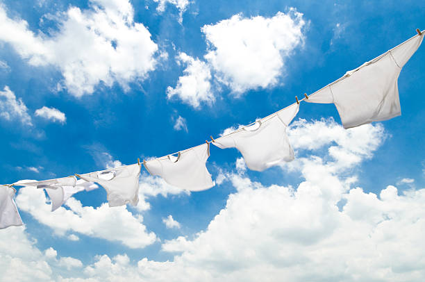 istock White clothes on a clothesline against a cloudy sky 461185207