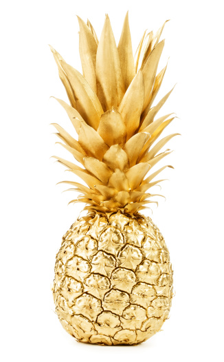 Pineapple in gold isolated on white background