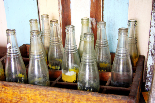 old bottle in wooden trunk