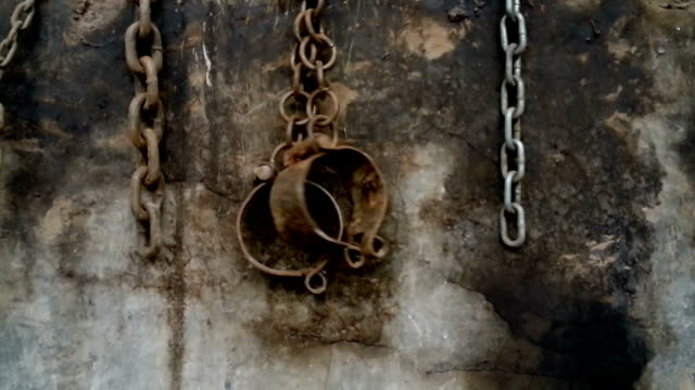 shackles and chains hanging on a wall