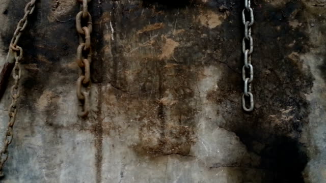shackles and chains hanging on a wall