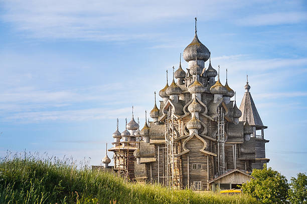 Church of The Transfiguration - Kizhi Island, Russia Built in the early 18th century, it is an octagonal spruce and pine log framework with 22 domes covered with birch bark. republic of karelia russia stock pictures, royalty-free photos & images