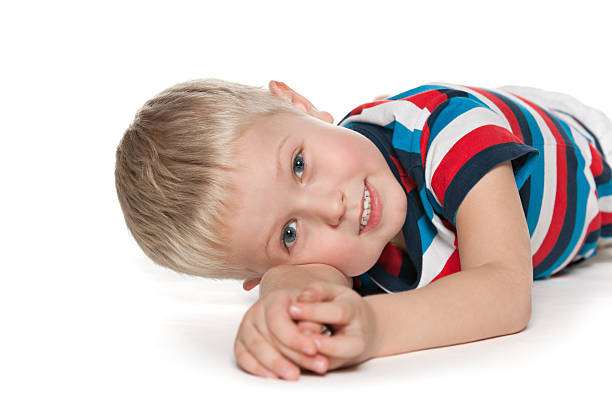 istock Preschool boy is lying on the white 461209085