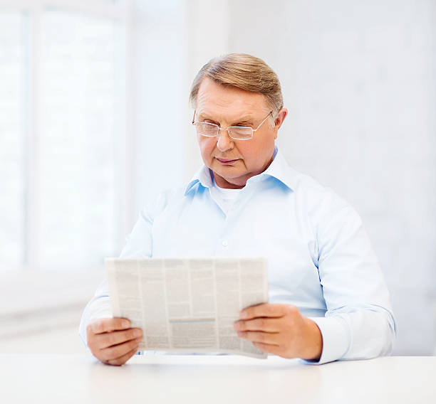 istock old man at home reading newspaper 461209595