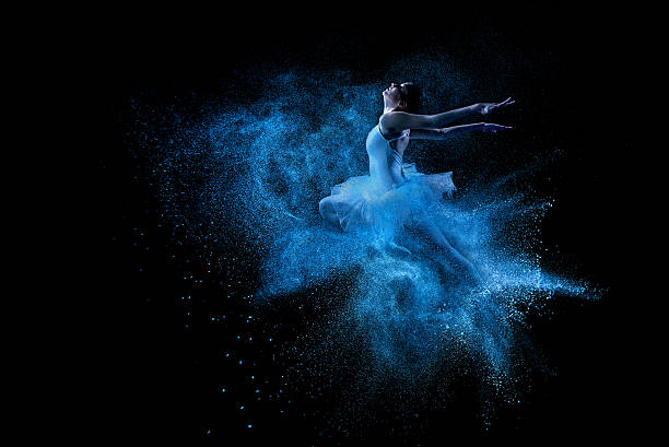 istock Young beautiful dancer jumping into blue powder cloud 461210091