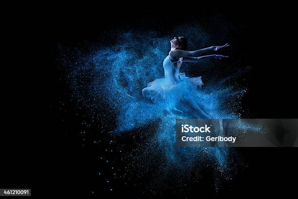 Young Beautiful Dancer Jumping Into Blue Powder Cloud Stock Photo - Download Image Now