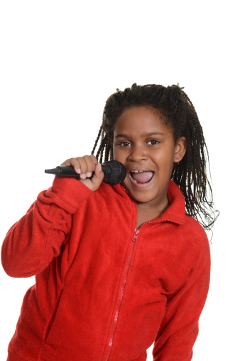isolated young jamaican girl with microphone