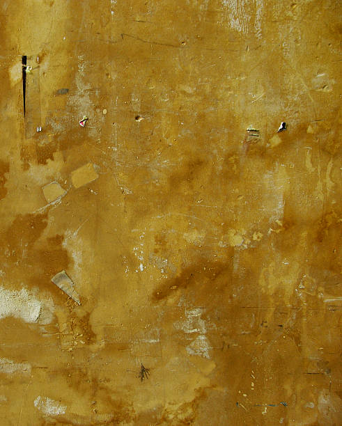 istock worn dirty brown orange grunge wall with leftovers from posters 461214447