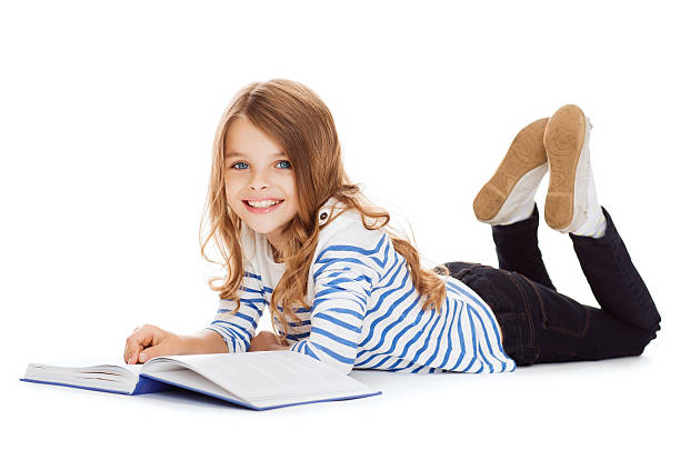 smiling little student girl lying on the floor