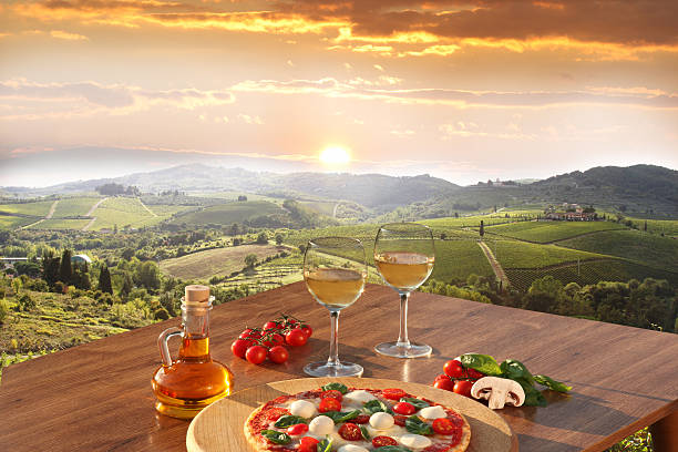 Chianti vineyards with  pizza and glasses of white vine, Italy Italian pizza and glasses of white wine in Chianti, famous vineyard landscape in Italy italian cheese stock pictures, royalty-free photos & images