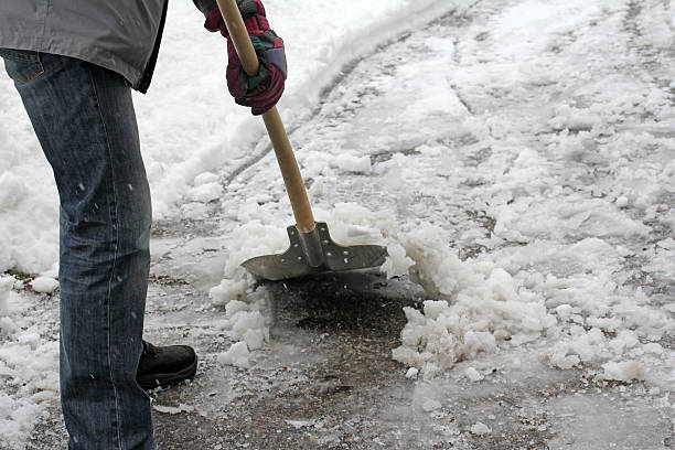 istock Man shoveling snow from this driveway or sidewalk 461220373