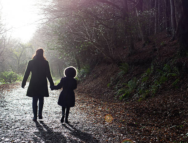istock Mother and daughter walking 461224715