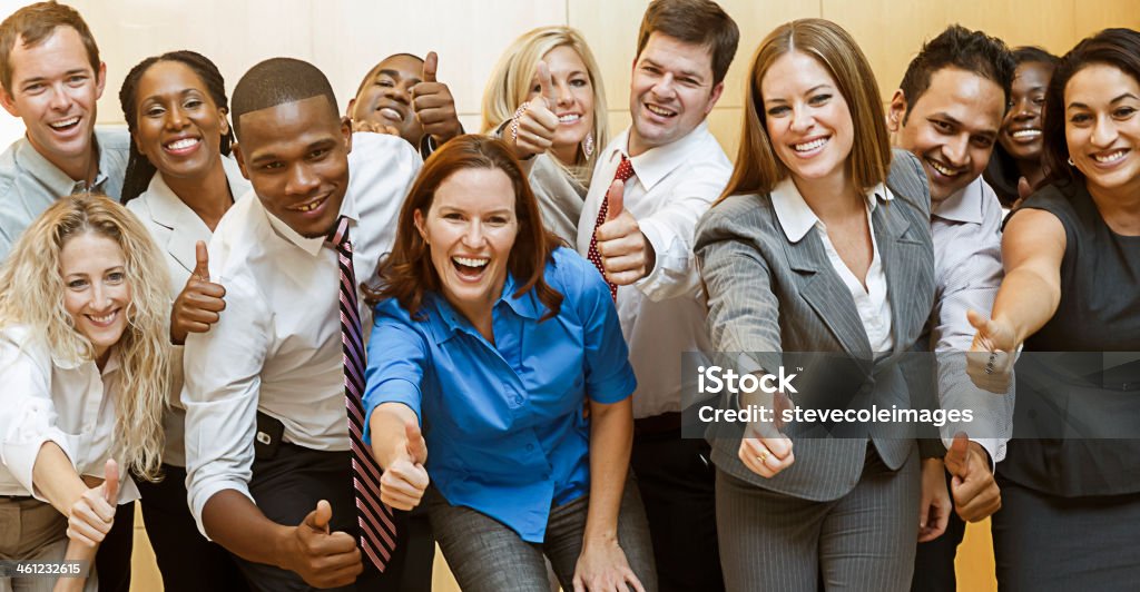 Business People Business people grouped together holding their thumbs up...BUSINESS.Exclusive only at istockphoto • stevecoleimages • Atlanta, Georgia. Adult Stock Photo