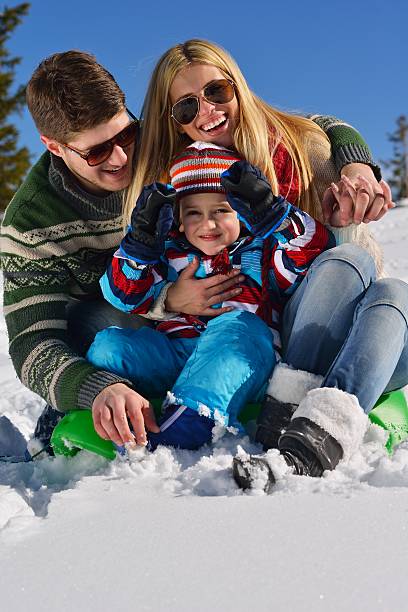 istock family having fun on fresh snow at winter 461232641