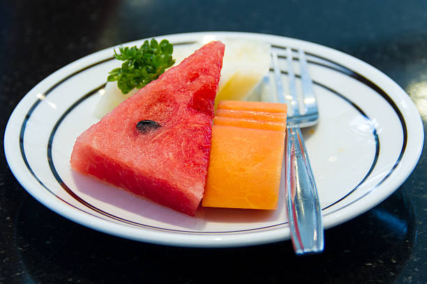 istock Watermelon, papaya and pineapple on a plate 461234983