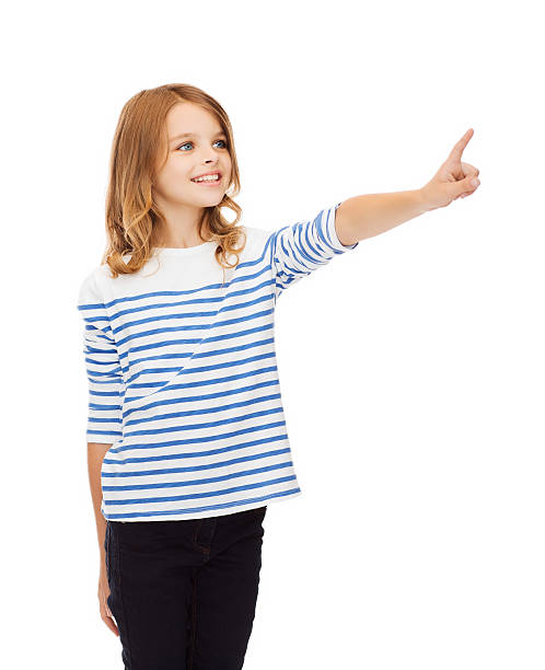 smiling girl pointing at virtual screen education, school and virtual screen concept - cute little girl pointing in the air or virtual screen campaign button photos stock pictures, royalty-free photos & images