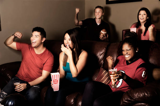 istock Sports: Friends cheer after their team scores. Media room. 461237121