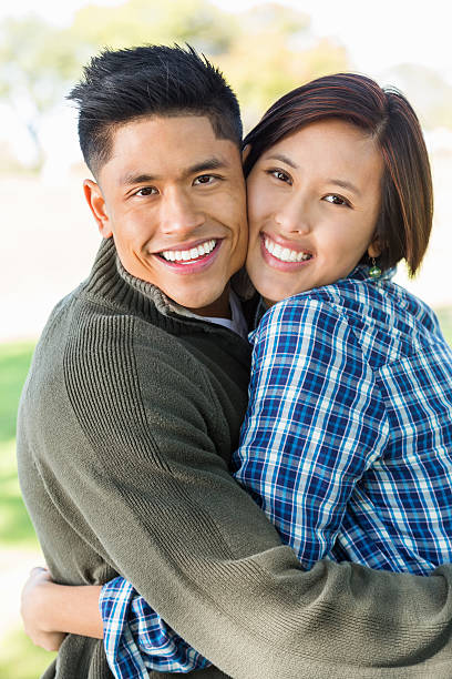 istock Happy young Vietnamese couple embracing at outdoor park 461237237