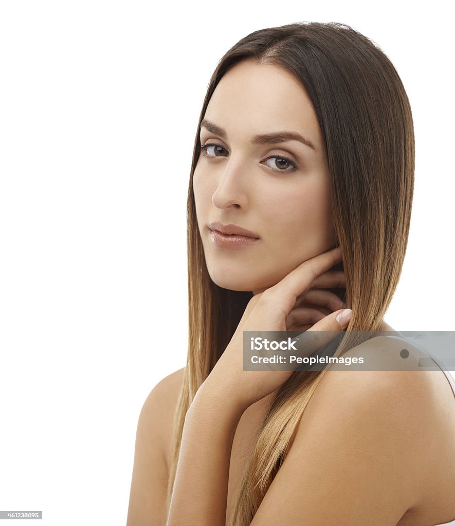 Smooth skin and luxurious hair Closeup of a beautiful young woman with her hand in her hair looking at the camera 20-24 Years Stock Photo