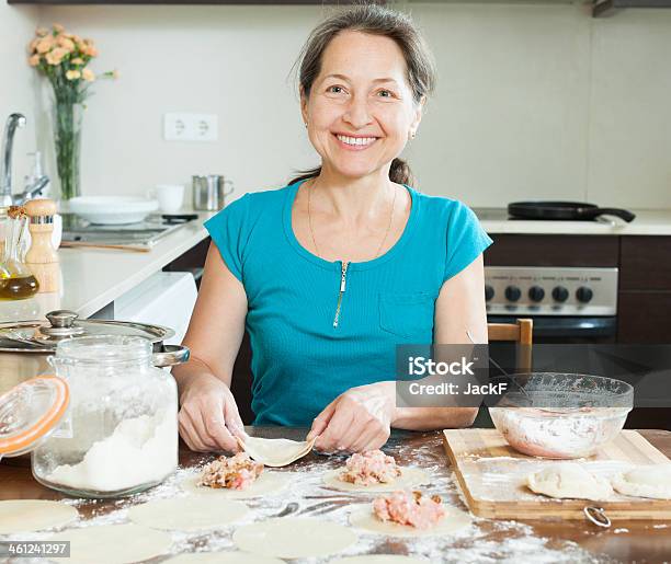 Smiling Mature Woman Making Meat Dumplings Stock Photo - Download Image Now - Cooking, Meat Pie, Adult