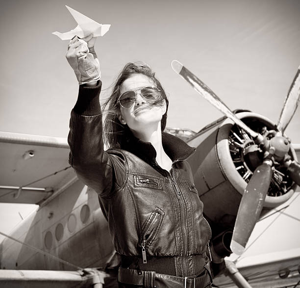 istock Young beautiful woman pilot in a airplane. 461252435