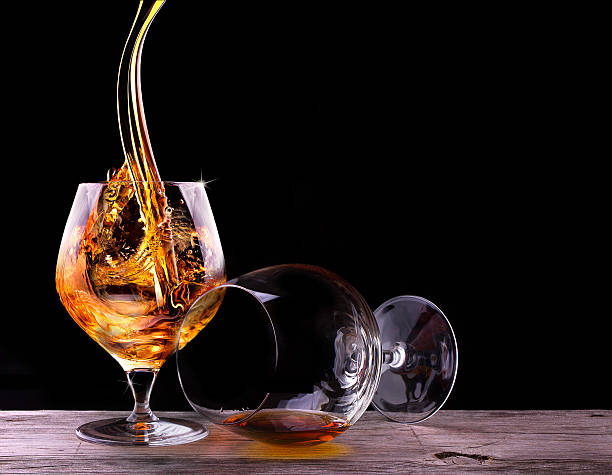Cognac or brandy on a black stock photo