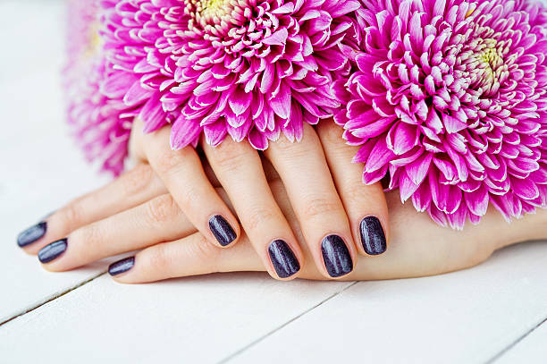 istock Hands with manicure and pink flower 461260737