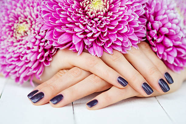 istock Hands with manicure and pink flower 461260741