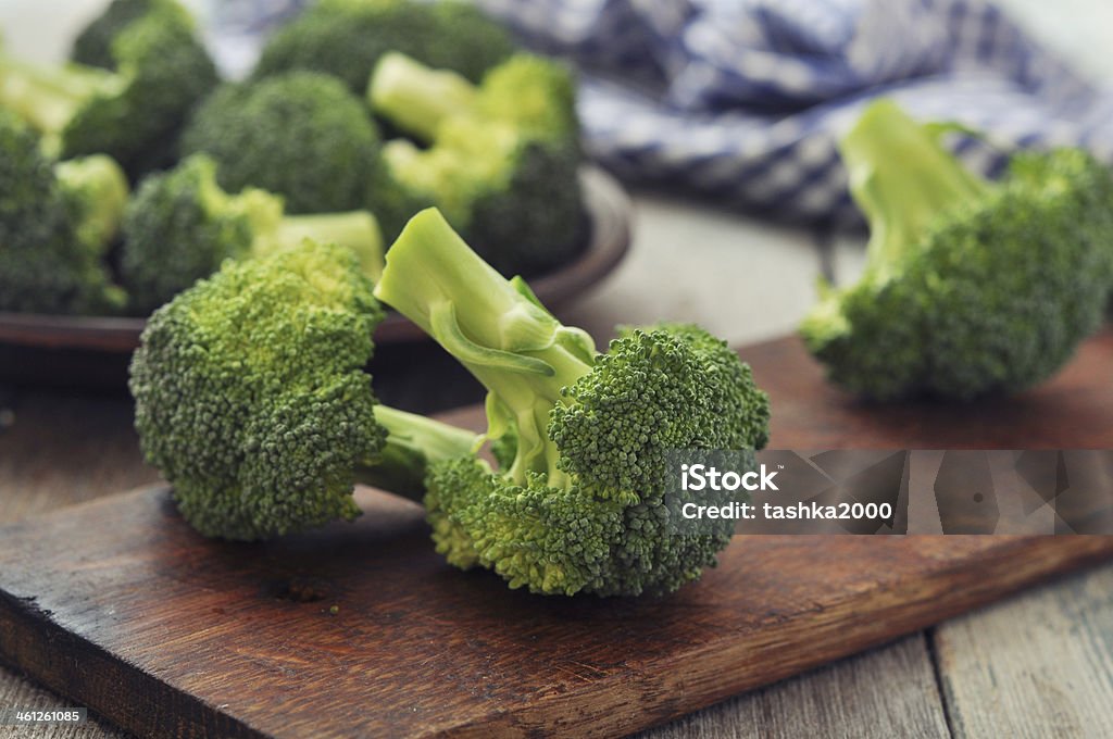 Fresh green broccoli Bunch of fresh green broccoli on wooden cutting board  closeup Agriculture Stock Photo