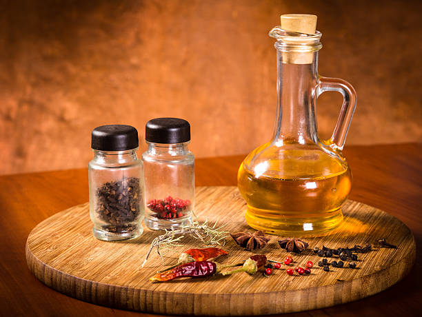 oil and spices on a cutting board oil, pepper and spices on a cutting board salt pepper ingredient black peppercorn stock pictures, royalty-free photos & images