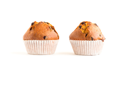 Two muffins with chocolate drops isolated on white
