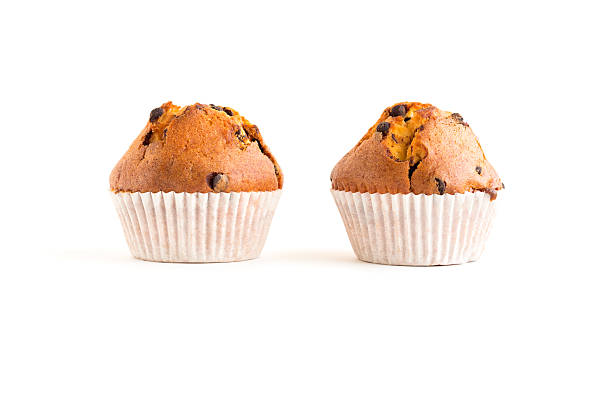 Two chocolate chip muffins isolated on white stock photo