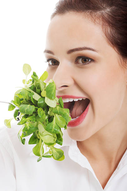 istock Young business woman eating lettuce. 461273533