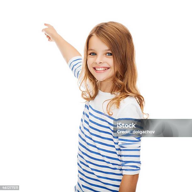 Smiling Girl Pointing At Something Invisible Stock Photo - Download Image Now - Girls, Student, Teenage Girls