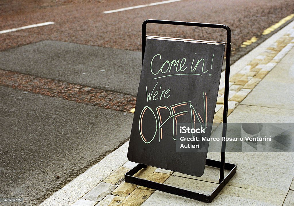 Come in we are open The blackboard reads: "Come in! We're OPEN" and "Fresh coffee served here" written in black on black at the bottom. Selective focus on the board. Scan from Portra 400. England, 2011 Open Sign Stock Photo