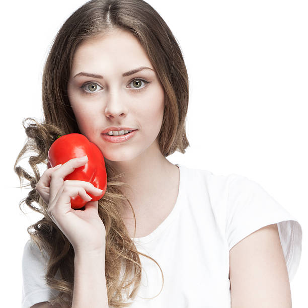 istock young beautiful brunette woman holding red pepper 461290849