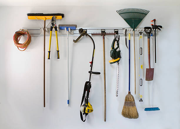 Neat garage tool hanging storage Neat garage tools hanging on a storage rack shed stock pictures, royalty-free photos & images
