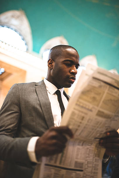 istock business man reading a newspaper inside the station 461304211