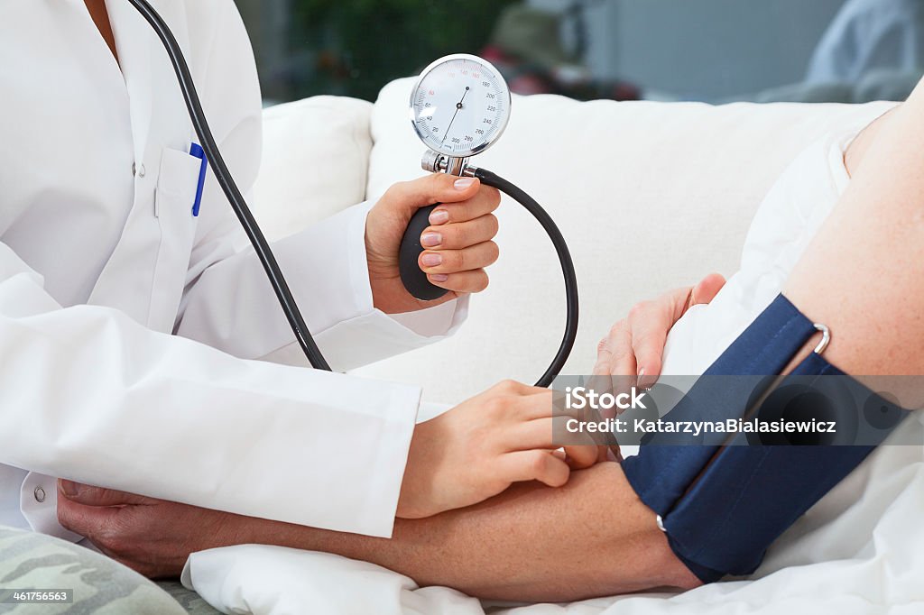 Measuring the blood pressure Measuring the blood pressure by doctor with pressure gauge Blood Pressure Gauge Stock Photo