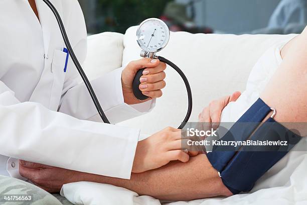 Measuring The Blood Pressure Stock Photo - Download Image Now - Blood Pressure Gauge, Heat - Temperature, Throat