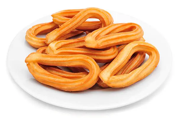 a plate with churros typical of Spain on a white background