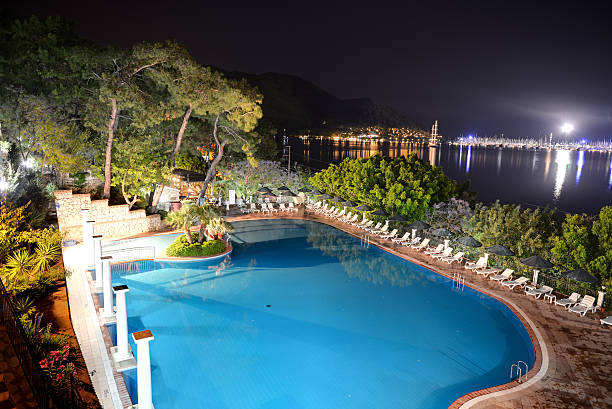 The swimming pool and view on yachts harbor in night illumination, Marmaris, Turkey