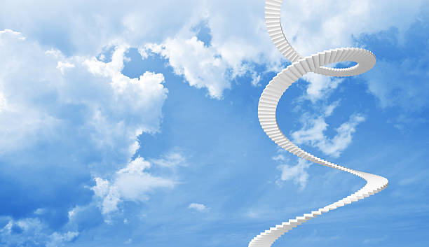 istock White spiral stairs goes up in blue cloudy sky 461781777