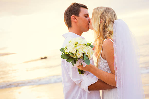 istock Just married couple kissing on tropical beach 461795457