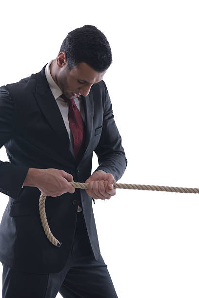 istock business man with rope isolated on white background 461797505