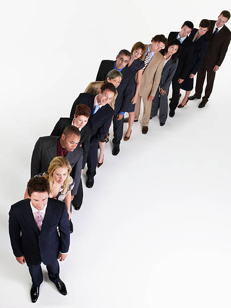 istock Businesspeople In Line Leaning Over 461807213