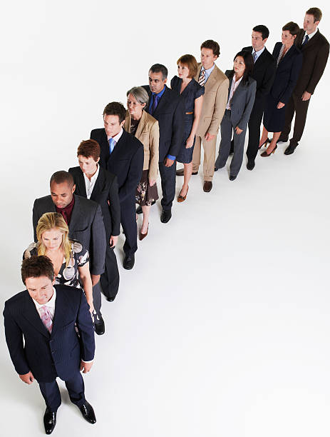 istock Businesspeople In Line Leaning Over 461807219