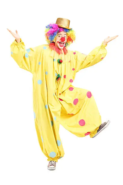 Photo of Full length portrait of a male funny circus clown posing