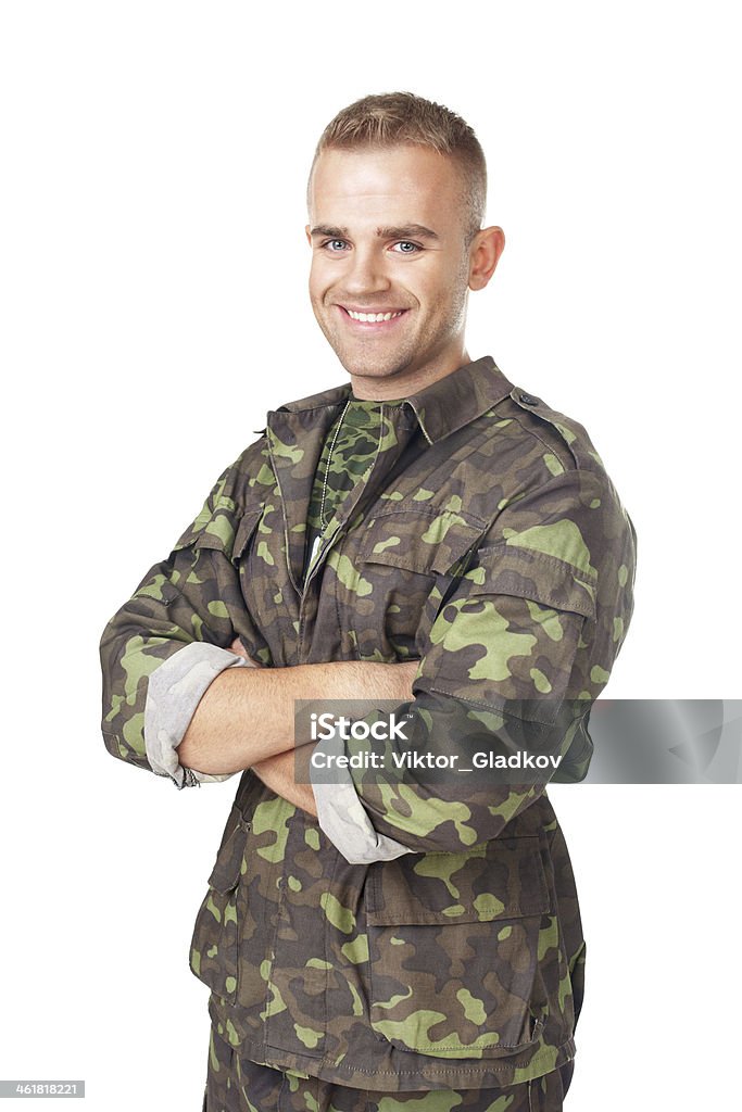 Smiling army soldier with his arms crossed Smiling army soldier with his arms crossed isolated on white background Camouflage Clothing Stock Photo